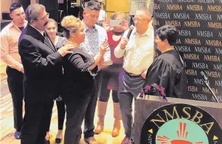  ??  ?? Pauline Jaramillo, center, with her husband, Robert, and other family members, takes the oath of office as president of the New Mexico School Boards Associatio­n in Santa Fe earlier this month. Jaramillo was first elected to the Socorro board of education in 2009.