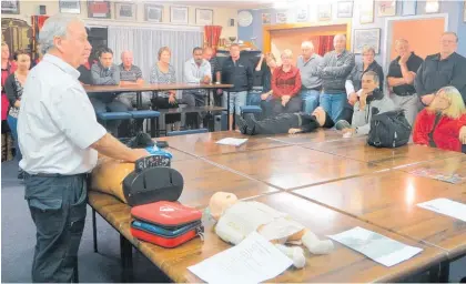  ??  ?? Neville explains how to use a defibrilla­tor to the After Five meeting of the Dannevirke Chamber of Commerce back in 2014 just as he is still doing today.