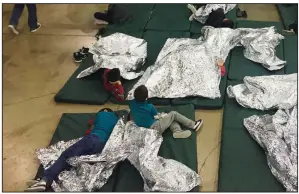  ?? AP/U.S. Customs and Border Protection ?? In this photo provided by U.S. Customs and Border Protection, youths rest in one of the cages at a center in McAllen, Texas, near the three “tender age” centers where babies and young children separated from their parents are being held.