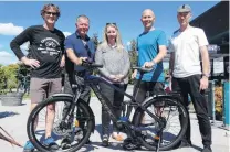  ?? PHOTO: MARK PRICE ?? Have ebike . . . Moustache ebike importer Campbell Read, of Queenstown, Stew Burt and Christina Perriam of the Canlive Charitable Trust, Mt Aspiring College teacher Andrew Sloane, and Matt Quirk of Good Rotations cycle shop, Wanaka, with the ebike presented to Mr Sloane.