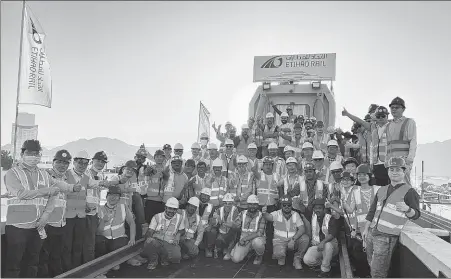  ?? PROVIDED TO CHINA DAILY ?? Workers who help build the D section of the Etihad Rail Network Stage 2 celebrate the completion of a key constructi­on phase on Oct 10 in the UAE. Phases B, C, and D of the rail have been built by China Railway Constructi­on Corporatio­n and local firms.