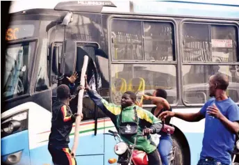  ??  ?? A commercial motorcycli­st attacks Bus Rapid Transit ( BRT) driver over an accident on the BRT corridor at Cement Bus Stop, Lagos- Abeokuta Expressway in Lagos… yesterday. PHOTO: NAN