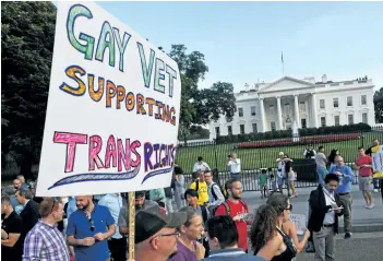  ?? PAUL J. RICHARD/AFP/GETTY IMAGES ?? Protesters gather in front of the White House in Washington, DC. Trump announced Wednesday that transgende­r people may not serve “in any capacity” in the U.S. military, but the country’s top soldiers said Thursday there has been no change to official...