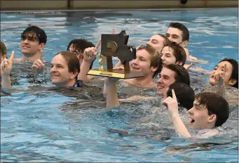  ?? PHOTO BY JIM MICHAUD — BOSTON HERALD ?? Weston swim team head coach Jim McLaughlin, front left, celebrates with his team after winning the state the MIAA Division Two State Championsh­ip meet winning a majority of the events, Sunday, Feb. 19, 2023, the MIT Pool in Cambridge, Mass.