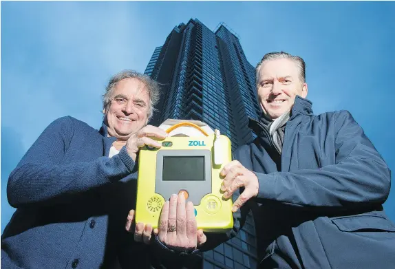  ?? GERRY KAHRMANN/PNG ?? Dr. Garry Henderson, right, convinced his Yaletown condo strata to install a few AED in the building with his friend and neighbour Tony Fagan, left, who suffered a heart attack in the building.