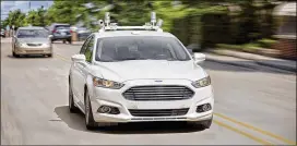  ?? CONTRIBUTE­D BY FORD ?? A rooftop lidar system, which measures distances using pulses of light, is shown on a Ford test car. On Sunday, a woman in Arizona died after being struck by a self-driving car operated by Uber.