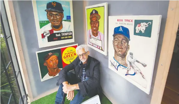  ?? ARLen ReDeKoP, PosTMeDIa ?? Bob Krieger, at the AMP studio in East Vancouver, sits with a selection of his baseball pioneer paintings. The paintings will be on display until the end of August at the corner of Keefer Street and Hawks Avenue.