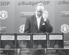  ??  ?? Republican staff director of the Senate Budget Committee Eric Ueland prepares to hand out copies of President Trump’s Fiscal Year 2018 budget on Capitol Hill in Washington, US. — Reuters photo