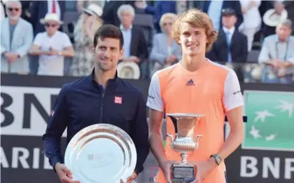  ??  ?? ROME: Alexander Zverev of Germany (R) poses with the trophy after winning the ATP Tennis Open final against Novak Djokovic (L) of Serbia on May 21, 2017, at the Foro Italico. — AFP photos