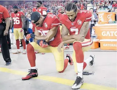  ?? MARCIO JOSE SANCHEZ/AP ?? Colin Kaepernick, right, and his former San Francisco 49ers teammate Eric Reid kneel during the national anthem four years ago. America owes them an apology.