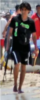  ??  ?? Gunman: Seifeddine Rezgui roams the beach in Sousse with an AK47