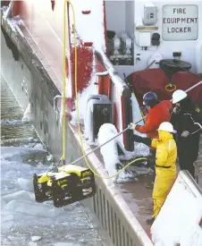  ?? NICK BRANCACCIO ?? Plane crash investigat­ors aboard the Canadian Coast Guard vessel Samuel Risley lower a remote-operated vehicle into Lake Erie near the crash site on Jan. 20, 2004.