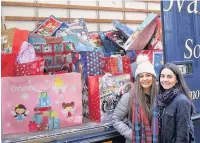  ??  ?? Pupils from Brynteg Comprehens­ive School delivering presents with the help from APSEE.