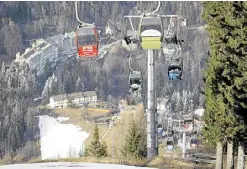  ?? ?? WARM WINTER A snowless village of Semmering lies in the background as a ski lift takes people up a slope of a resort on Jan. 8.