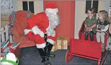  ??  ?? Izzy Brand and Katie Fleming meet Santa in his grotto 01_B48santa10