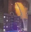  ?? ?? Firefighte­rs tackle the high-rise blazein Urumqi