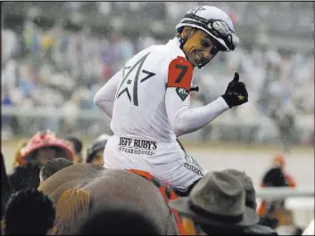  ?? Garry Jones The Associated Press ?? With Saturday’s victory Mike Smith, 52, became the second-oldest winning jockey in Derby history. Bill Shoemaker was 54 when he won with Ferdinand in 1986.