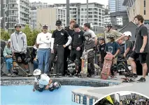  ??  ?? A crowd watches Monty Graham, 8, practise his skateboard tricks.