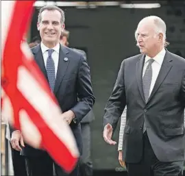  ?? Christina House Los Angeles Times ?? L.A. MAYOR Eric Garcetti, left, and Gov. Jerry Brown at a news conference in May. No one has ever gone directly from any City Hall to the White House.