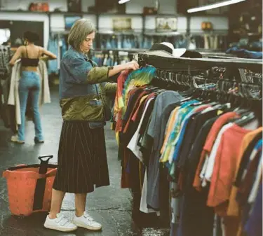  ?? TESS AYANO/THE NEW YORK TIMES ?? Erin Beatty, the creative director of Rentrayage, shops for vintage clothing May 3 in New York.