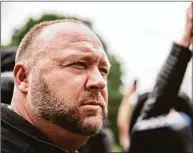  ?? Sergio Flores / Getty Images ?? The attorneys for nine Sandy Hook families claim in a new court filing that Alex Jones has been making “fraudulent transfers” between his companies to hide assets.