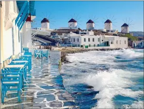  ??  ?? ISLAND IDYLL: The picture-postcard image of Mykonos and its windmills