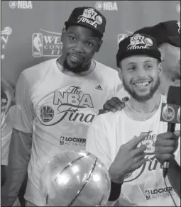  ?? The Associated Press ?? BAY WATCH: First-year teammates Kevin Durant, left, and Stephen Curry celebrate the Golden State Warriors’ third-straight NBA Western Conference championsh­ip Monday night in San Antonio, where the Warriors completed a four-game sweep of the Spurs.