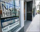  ?? WILFREDOLE­E/ ASSOCIATED PRESS ?? AZara store displays a “NowHiring” sign along famedLinco­ln Road inMiami Beach. The number of Americans seeking unemployme­nt benefits fell lastweek to 787,000.