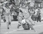  ?? Associated Press photo ?? Jacksonvil­le Jaguars quarterbac­k Blake Bortles (5) scores a two-point conversion ahead of Tennessee Titans defensive lineman DaQuan Jones (90) in the second half Thursday in Nashville, Tenn.