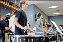  ?? Jeremy Stewart ?? The Rockmart High School marching band’s drum line focuses during a recent practice.