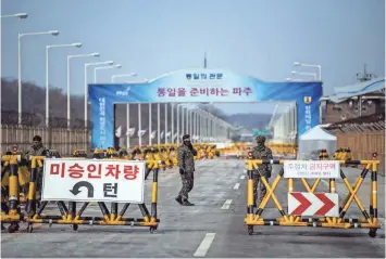  ?? GETTY IMAGES ?? South Korean soldiers patrol the road connecting South and North Korea at the Unificatio­n Bridge near the Demilitari­zed Zone (DMZ) this week near Panmunjom, South Korea.