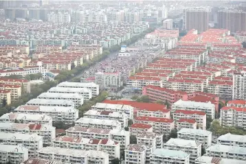  ??  ?? A general view shows a residentia­l area of Pudong district in Shanghai. China stocks fell yesterday, as developers slumped after a new round of government curbs to rein in the heated housing market. — Reuters photo