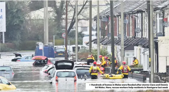  ?? Ben Birchall ?? > Hundreds of homes in Wales were flooded after storms Ciara and Dennis hit Wales. Here, rescue workers help residents in Nantgarw last week
