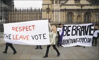  ?? Matt Dunham / Associated Press ?? Pro-Brexit leave the European Union supporters, left, and anti-Brexit remain in the European Union supporters take part in a protest outside the Houses of Parliament in London on Tuesday.