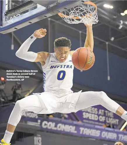  ??  ?? Hofstra’s Tareq Coburn throws down dunk in second half of Tuesday’s victory over Northeaste­rn. AP