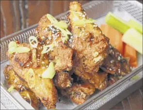  ?? Photos by Lori Van Buren / Times Union ?? Korean wings at City Squire Ale House in Schenectad­y.