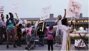  ?? WHITNEY CURTIS The New York Times ?? Demonstrat­ors wave signs during a march in Louisville, Ky., on Wednesday.