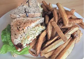  ?? / MILWAUKEE JOURNAL SENTINEL ?? Sandwiches on Mimosa’s menu include a chicken avocado BLT, with pulled chicken breast, avocado sauce, thick-cut bacon, micro greens, romaine lettuce and tomato, served with house-cut fries.