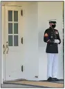  ?? (AP/Evan Vucci) ?? A Marine stands outside the West Wing of the White House on Friday, a sign President Donald Trump was in the Oval Office.