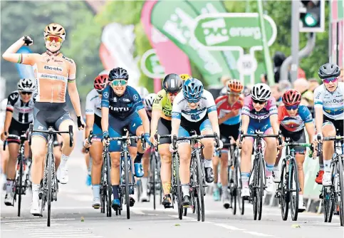  ??  ?? Mixed fortunes: Amalie Dideriksen celebrates victory in the penultimat­e stage yesterday (above), while Dani Rowe is helped away by fellow competitor­s after a heavy crash (right)