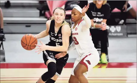  ?? Michael Woods / Associated Press ?? UConn’s Paige Bueckers (5) drives against Arkansas defender Makayla Daniels during the second half on Thursday in Fayettevil­le, Ark.