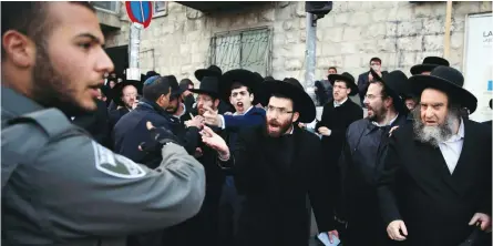  ?? (Ammar Awad/Reuters) ?? ULTRA-ORTHODOX JEWS take part in a demonstrat­ion against members of their community serving in the IDF, in Jerusalem.