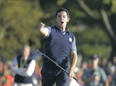  ?? Charlie Riedel/Associated Press ?? Europe’s Rory McIlroy reacts after making his putt to win his match, 3 and 2, in a four-balls match at the Ryder Cup Friday at Hazeltine National Golf Club in Chaska, Minn.