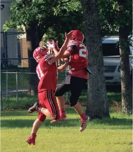  ??  ?? Two LFO players compete in a catching drill during a spring practice. The Warriors are scheduled to scrimmage at East Ridge this Friday. (Catoosa News photo/Robert Magobet)