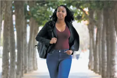  ?? Paul Chinn / The Chronicle ?? Sheena Lyons walks to her job in San Francisco. She attended SVAcademy after college to learn business skills that would help her getting into the tech industry, which typically focuses on a narrower talent pool.