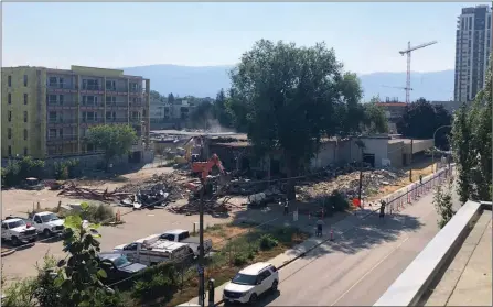  ?? HEATHER HOLLINGWOR­TH/Special to The Daily Courier ?? A building that for decades housed The Daily Courier newsroom and printing press was torn down Friday to make way for the UBC tower.