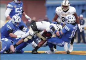  ?? COURTESY BYU PHOTO ?? BYU senior linebacker Sione Takitaki, right, drags down a Western Michigan player during the 49-18Cougar win in the 2018Famous Idaho Potato Bowl on Friday, Dec. 21, 2018.
