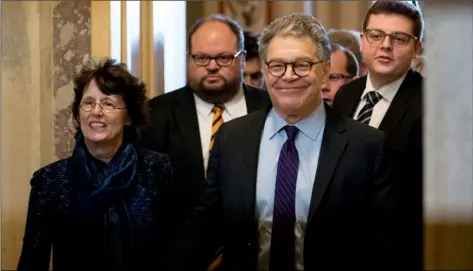  ??  ?? In this 2017 file photo, Sen. Al Franken, D-Minn. (second from right) holds hands with his wife Franni Bryson, left, as he leaves the Capitol after speaking on the Senate floor on Capitol Hill in Washington. AP PhoTo/Andrew hArnIk