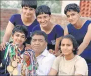  ?? HT PHOTO ?? ▪ A young Vinesh Phogat (back row centre) with her sisters and uncle Mahavir at her village in Haryana.