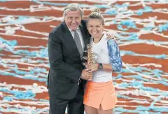  ?? REUTERS ?? Simona Halep holds the Madrid Open trophy with Illie Nastase.